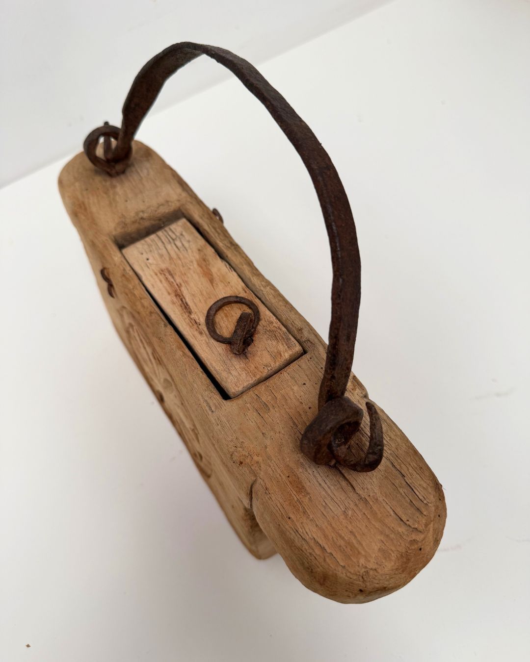 Vintage Indian Oil Pot with decorative carvings on a white 