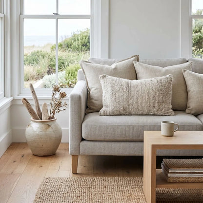 Living room with a beige sofa, coffee table, and decorative items.