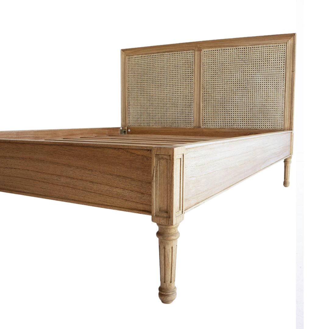 Wooden bed with rattan headboard on a white background