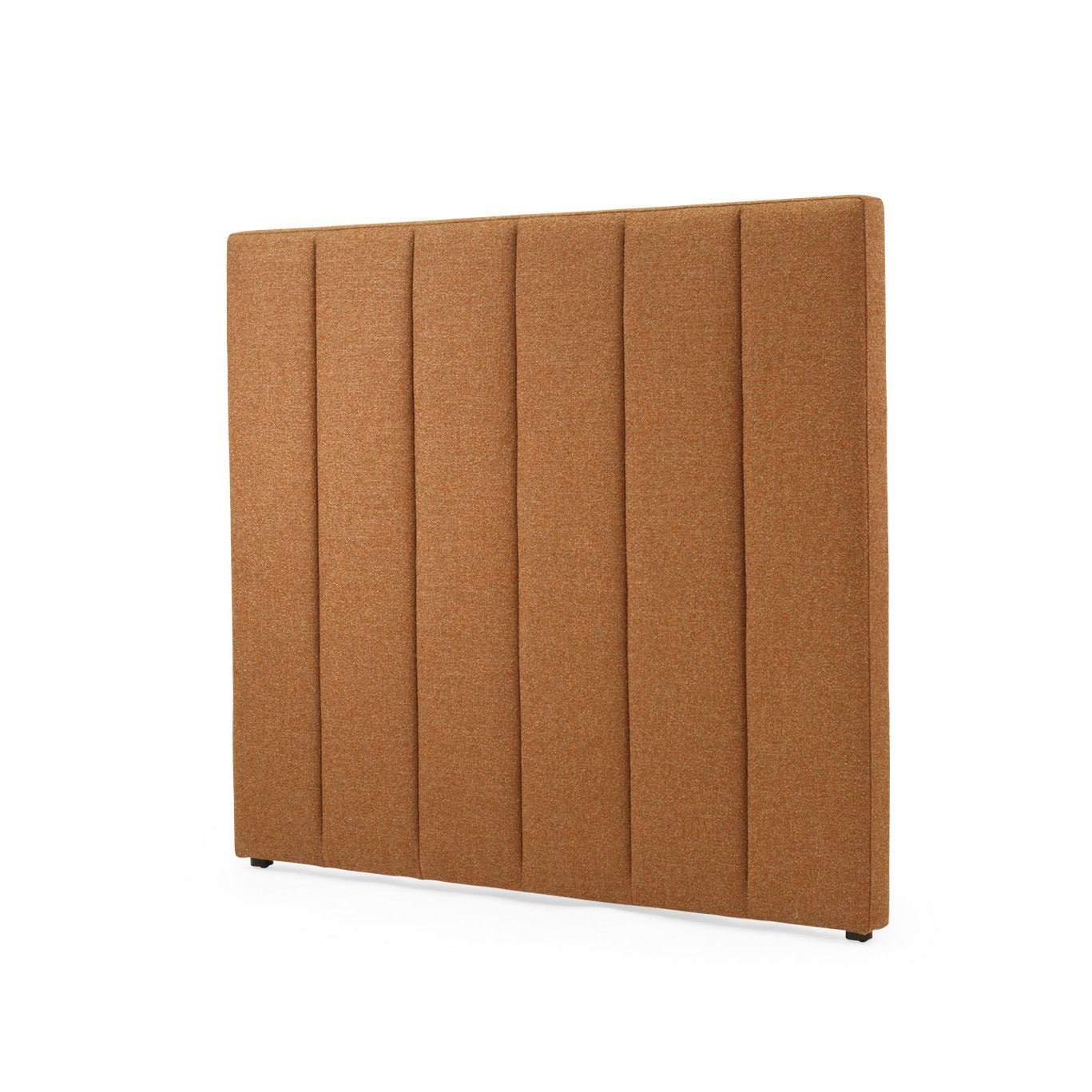 A rectangular upholstered headboard in a warm camel brown fabric, featuring vertical channel tufting, shown on a plain white background.