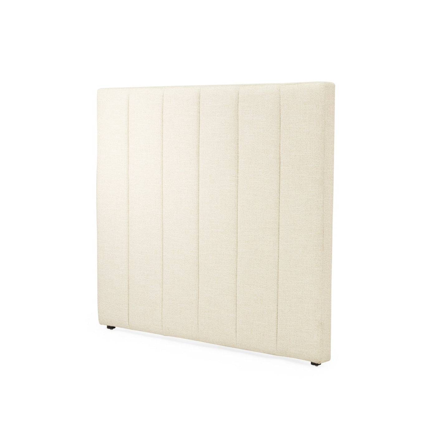 An upholstered rectangular headboard in a warm cream or off-white fabric, featuring vertical channel tufting, shown against a plain white background.