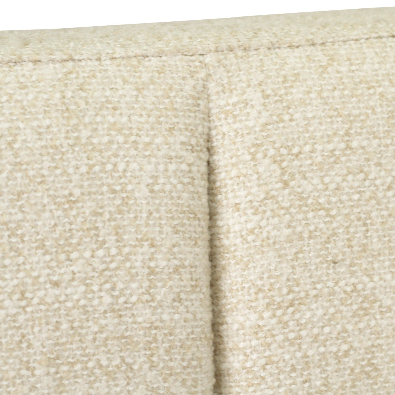 Close-up of a textured beige fabric upholstery with a vertical channel tufting seam.