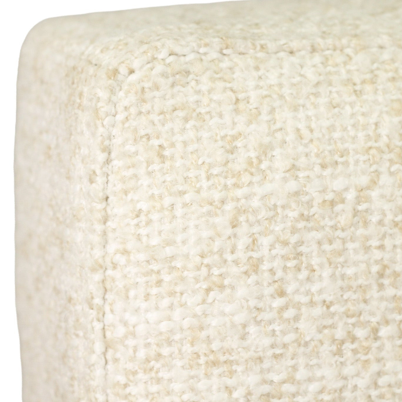 Close-up of a textured fabric upholstery in a warm off-white or cream color, showing the woven material and corner seam.