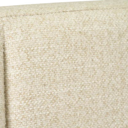 Close-up of a textured beige fabric upholstery with a vertical channel tufting seam.