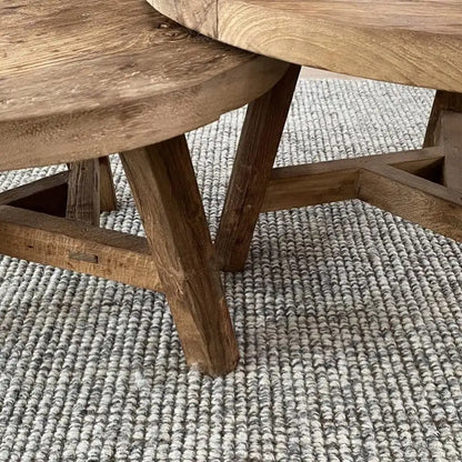 Close-up of wooden furniture on a textured grey and white blend rug