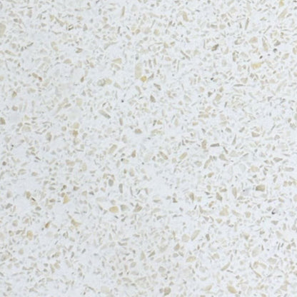 Close-up of a textured white surface with small beige particles