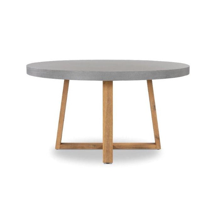A round dining table featuring a smooth gray concrete top and a natural light brown wooden base with angled legs and a central crossbar, shown on a plain white background.