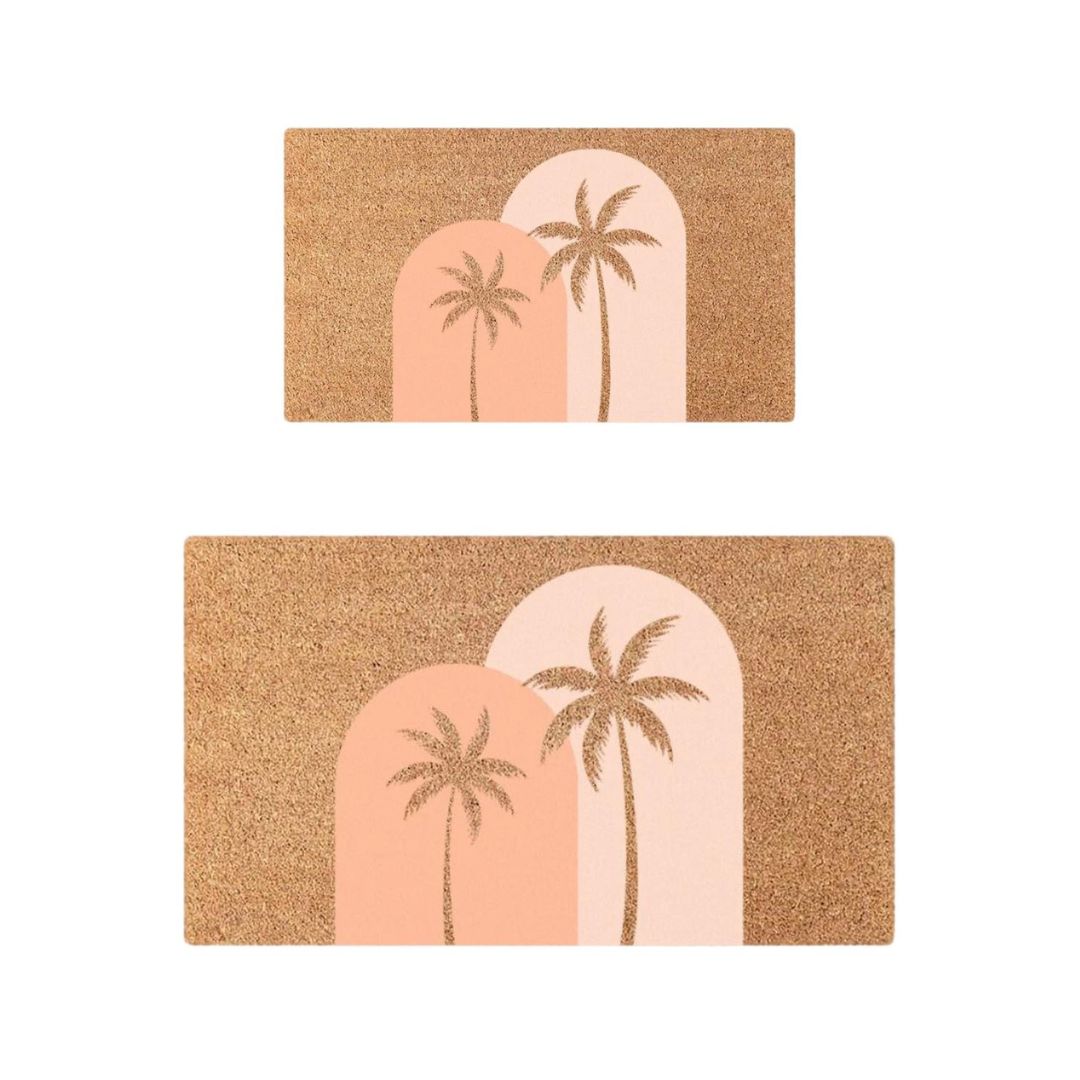 Two doormats with palm tree design on a white background