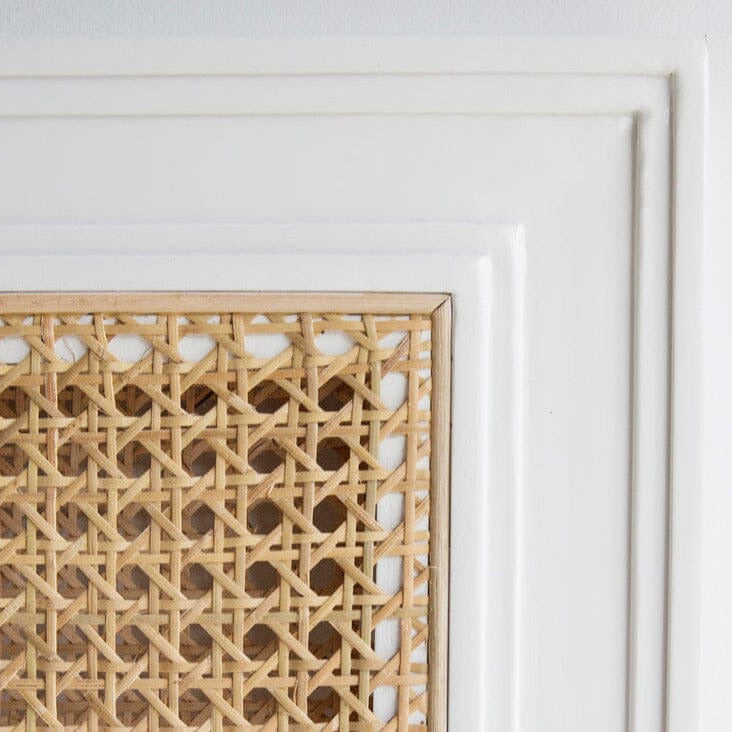 Square bedhead with white frame and woven natural material on a white background