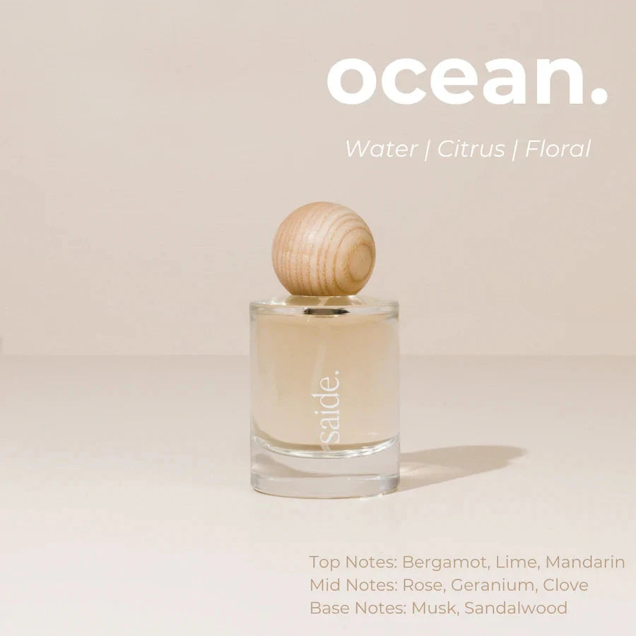 Perfume bottle with wooden cap on a beige background, featuring the brand 'sable'.