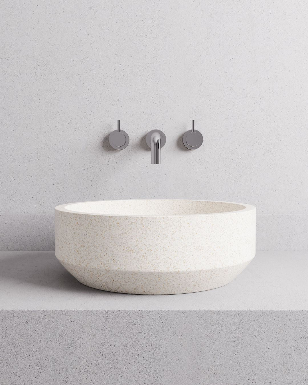 Modern bathroom sink with faucet against a light gray wall
