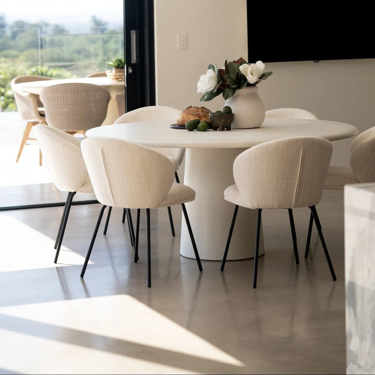 Modern dining room with a round table and chairs in a bright setting