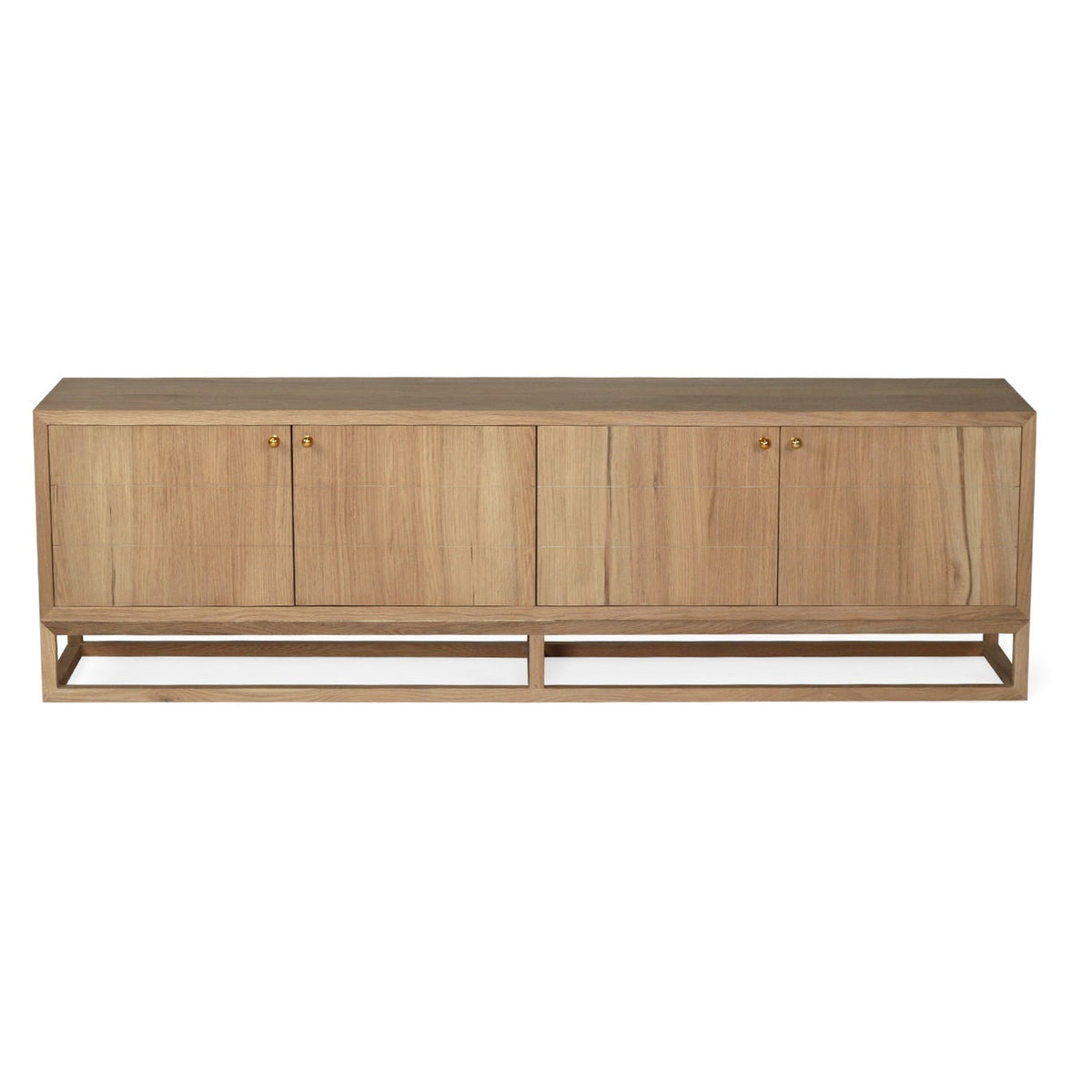 A mid-century modern sideboard cabinet made of light oak wood, featuring four doors with small brass knobs and a matching metal frame base, shown against a plain white background.
