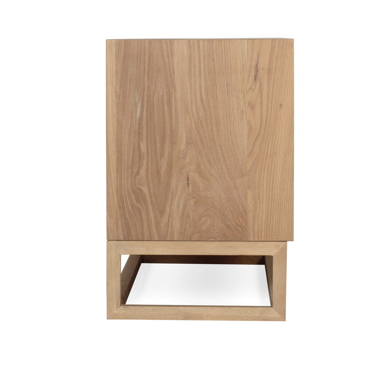 A modern wooden cabinet or side table with a natural oak finish, featuring a tall rectangular upper section and a geometric open base, shown against a plain white background.