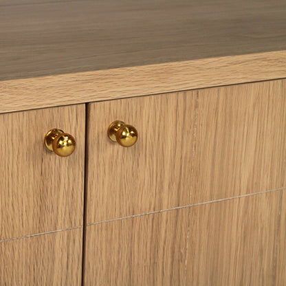 Close-up of a wooden cabinet with two doors, featuring round polished brass knobs and a medium brown wood grain finish.