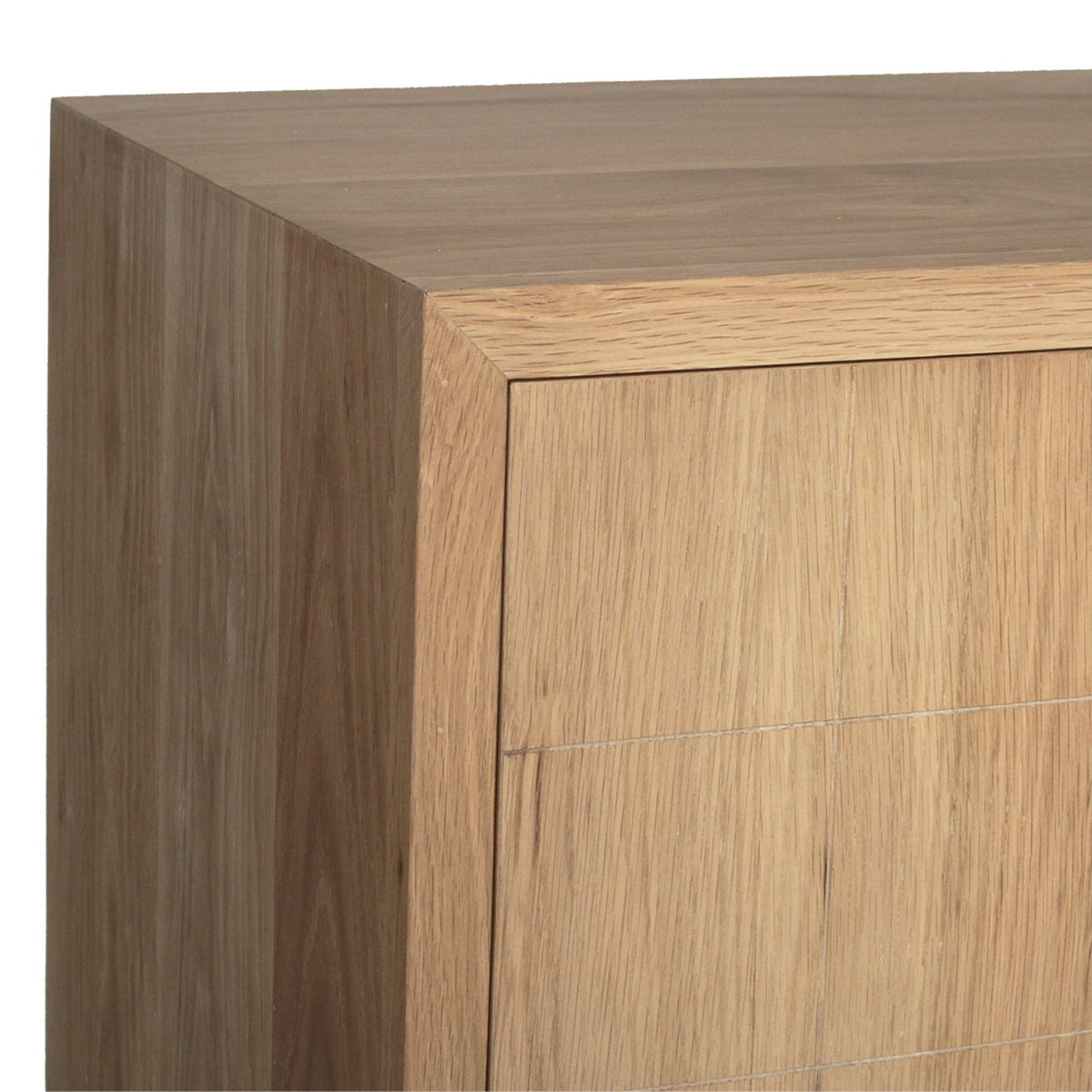 Close-up of a light oak wood cabinet corner showing the top surface, front panel, and side edge against a white background.