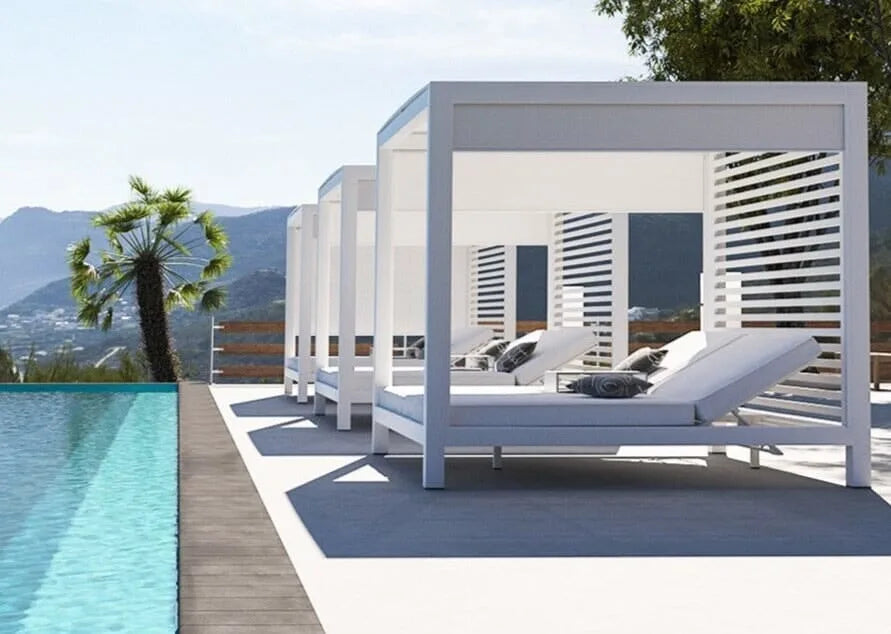 Luxury white sunlounge cabana by a pool with mountains in the background