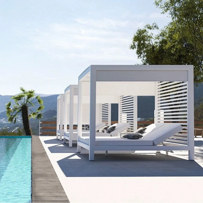 White sunlounge cabana by a pool with a scenic background