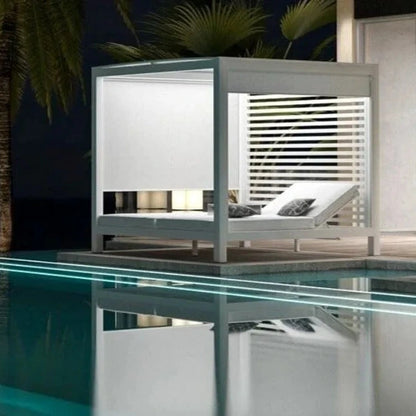 Modern outdoor cabana by a pool with palm trees at night.