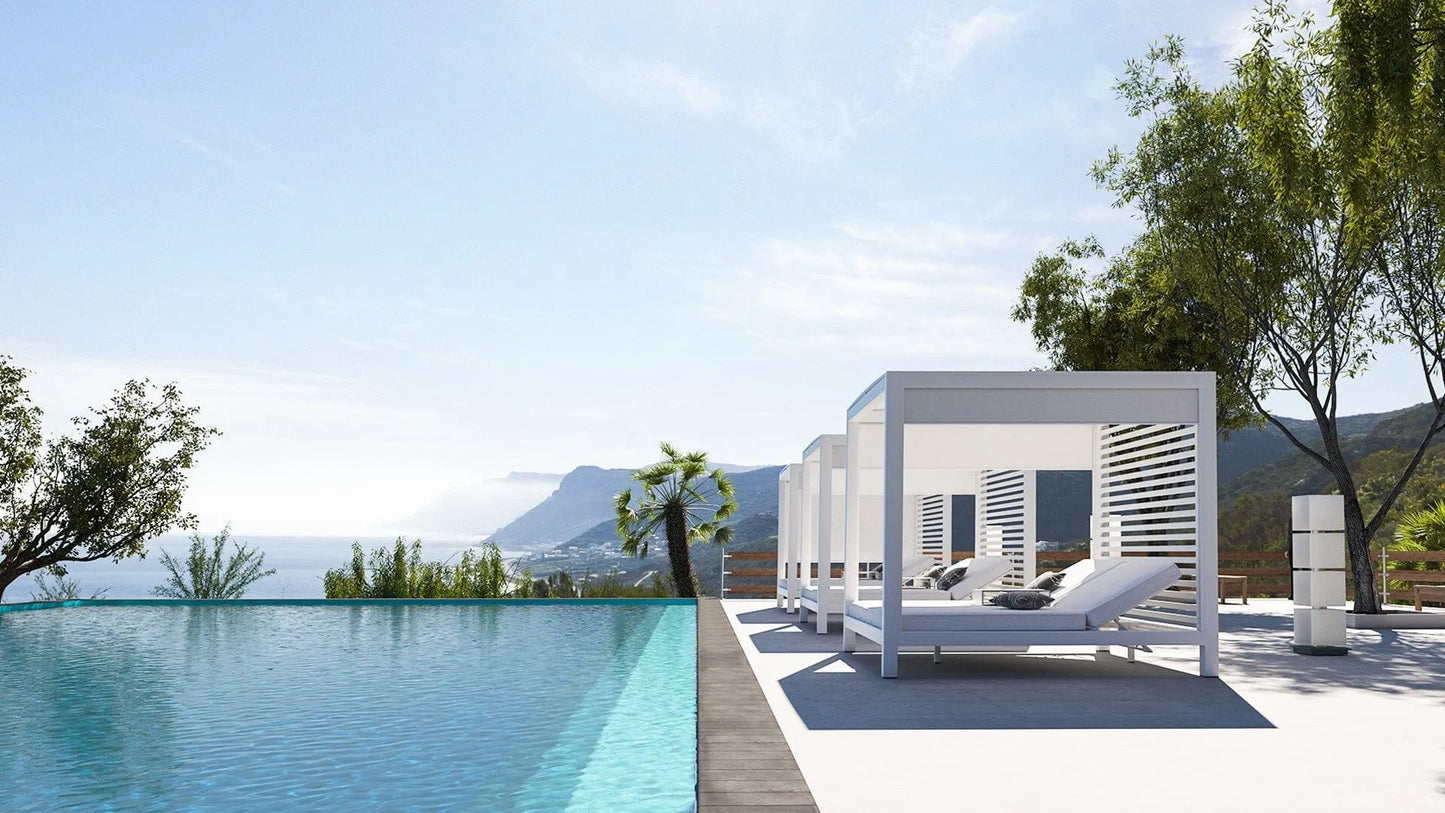 Modern outdoor pool area with a cabana and lounge chair, surrounded by trees and mountains.