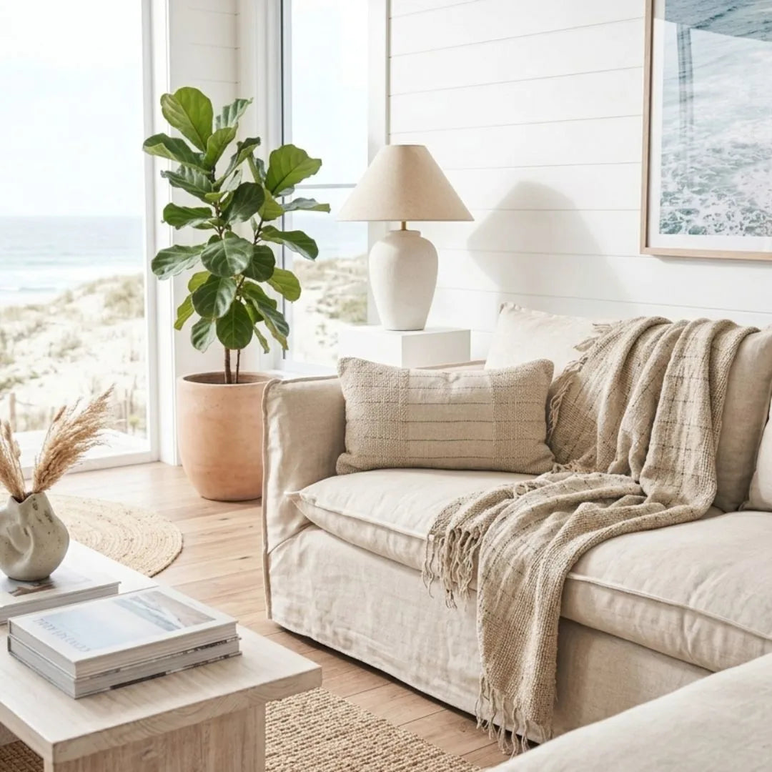 Cozy living room with beige sofa, lamp, and plant