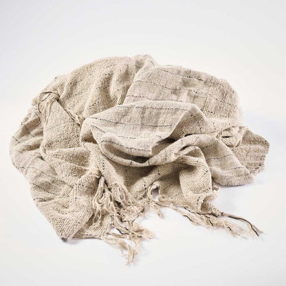 Beige woven blanket with tassels on a white background