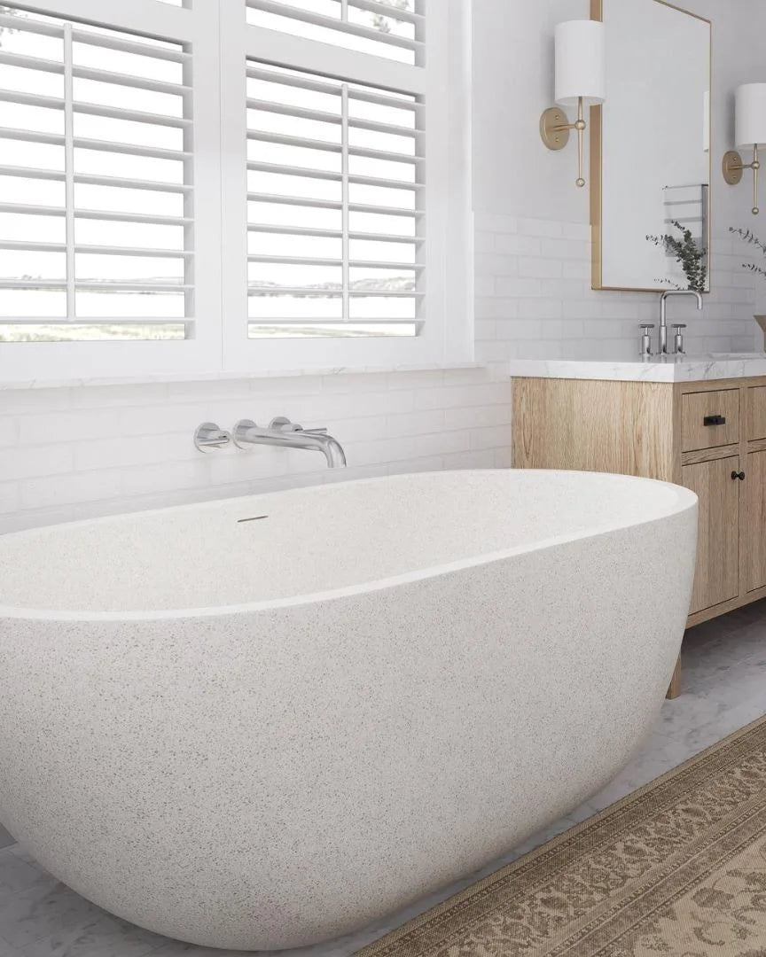 Modern bathroom with a freestanding bathtub, wooden vanity, and large window.