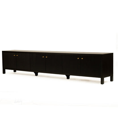 A long black sideboard or credenza with six cabinet doors and small round gold knobs, photographed against a plain white studio background.