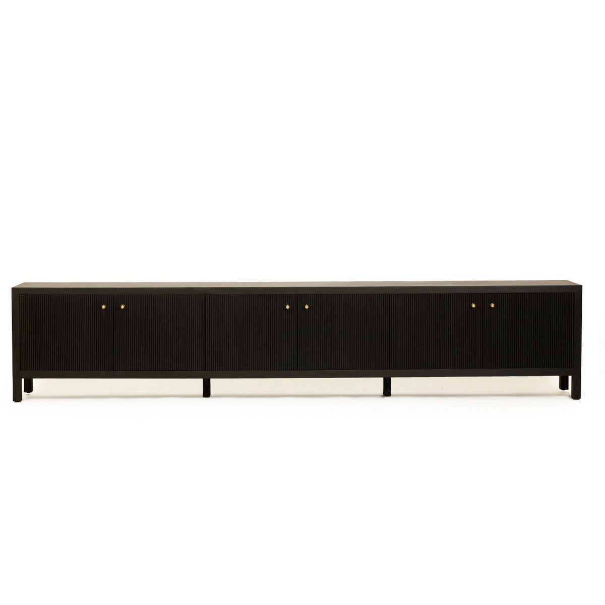 A long black wooden sideboard or credenza with four cabinet doors, each featuring a small round gold pull, shown against a plain white background.