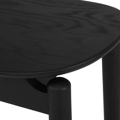 close up of the Jansen American Oak Counter Saddle Stool in black 