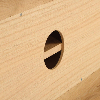 Close-up of a wooden surface with a circular cutout