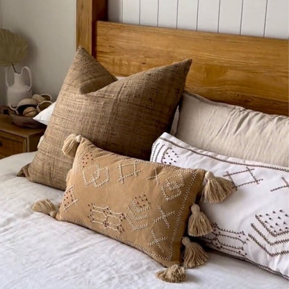 Decorative pillows on a bed with a wooden headboard