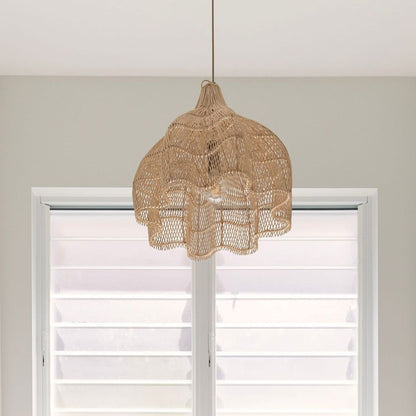 Lotus woven rattan pendant light from sun republic hanging in front of a window with white blinds.