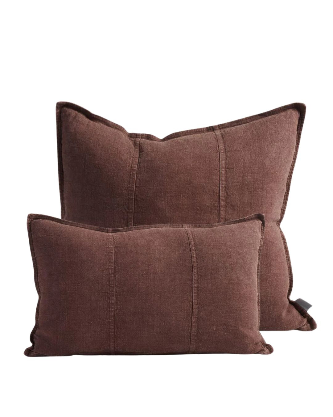Two chocolate brown pillows on a white background