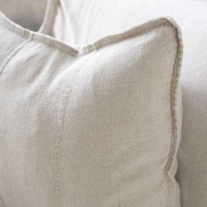 Close-up of a beige textured pillow on a neutral background.