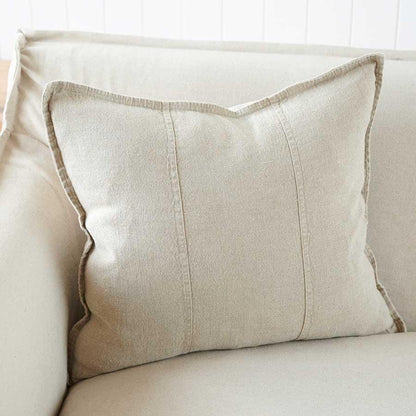 Beige pillow on a sofa in a bright room