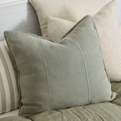 Close-up of textured pillows on a sofa with a neutral color palette.