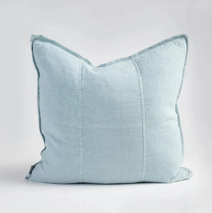 Light blue pillow with textured trim on a white background
