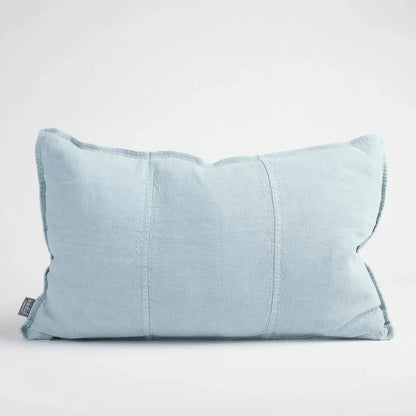 Light blue pillow on a neutral background