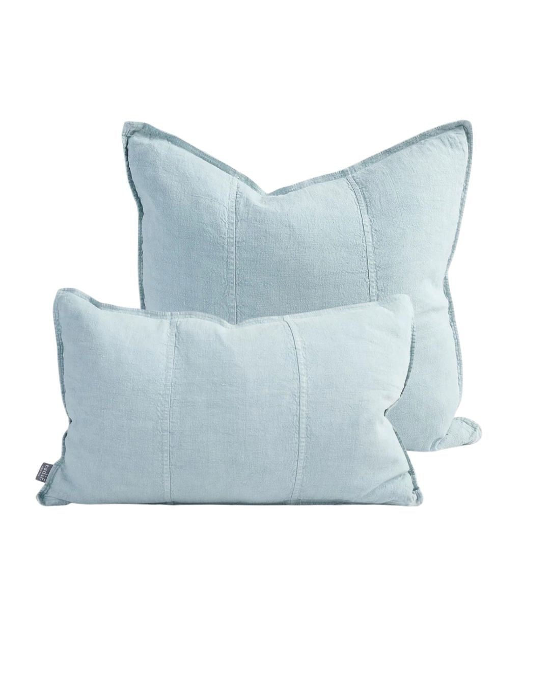 Two light blue pillows on a white background