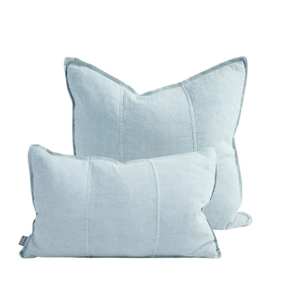 Two light blue pillows on a white background