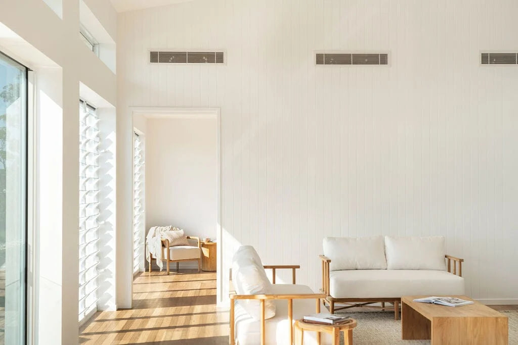 Modern living room with white furniture and wooden floor