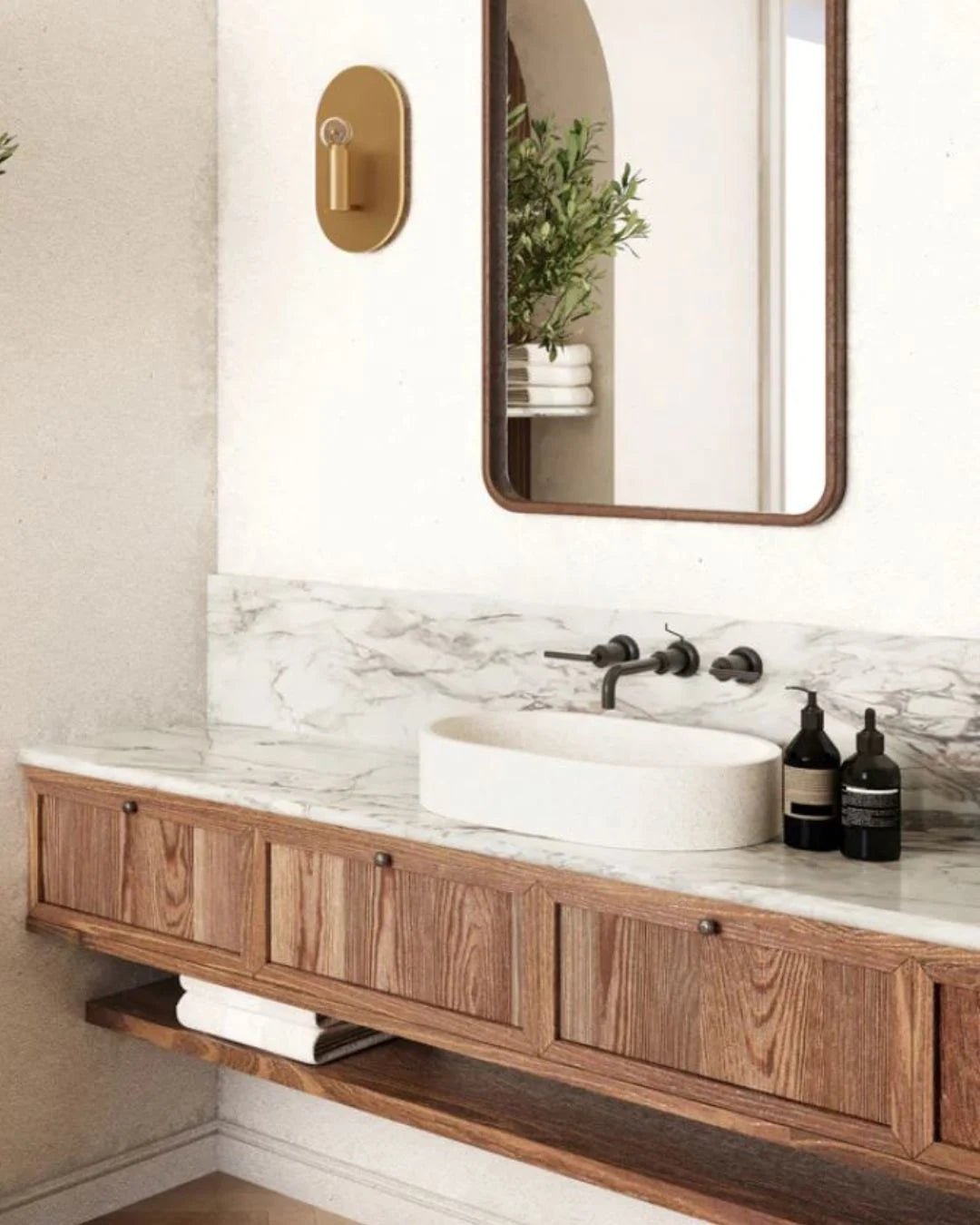 Bathroom vanity with wooden cabinet, marble countertop, and mirror.