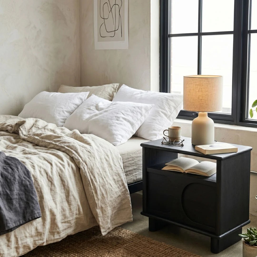 Bedroom with a bed and nightstand next to a window