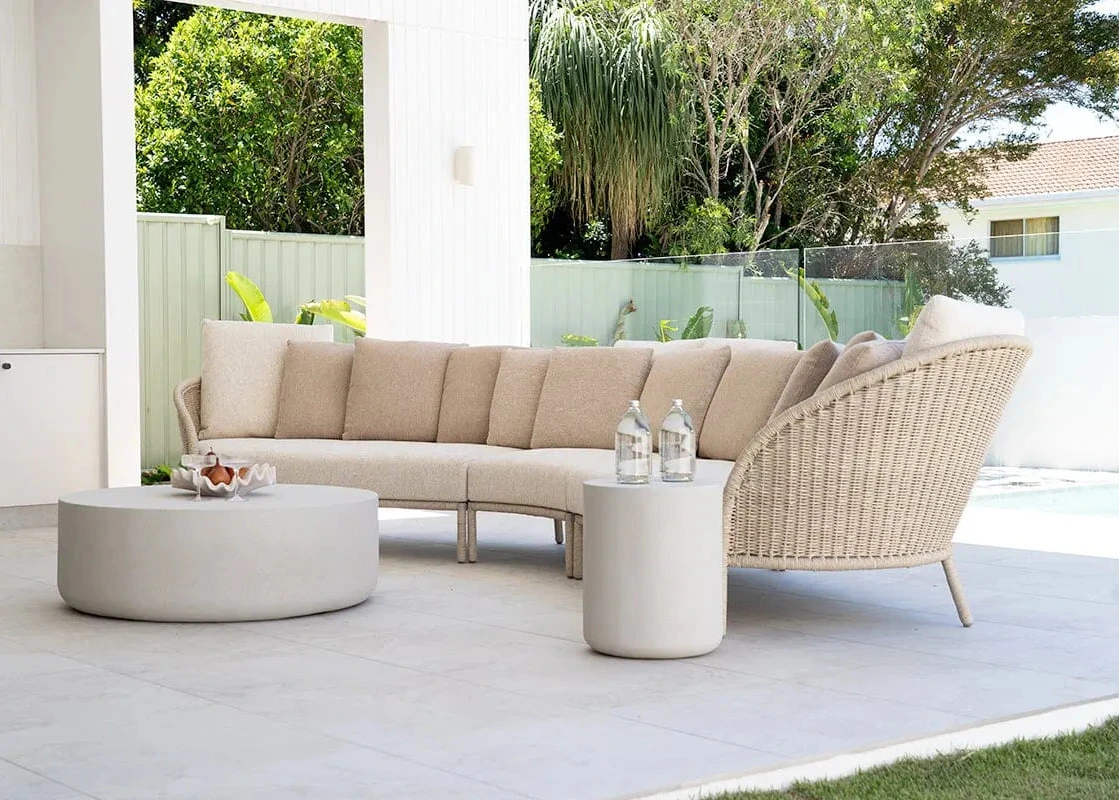 Beige outdoor sofa set with coffee table on a patio