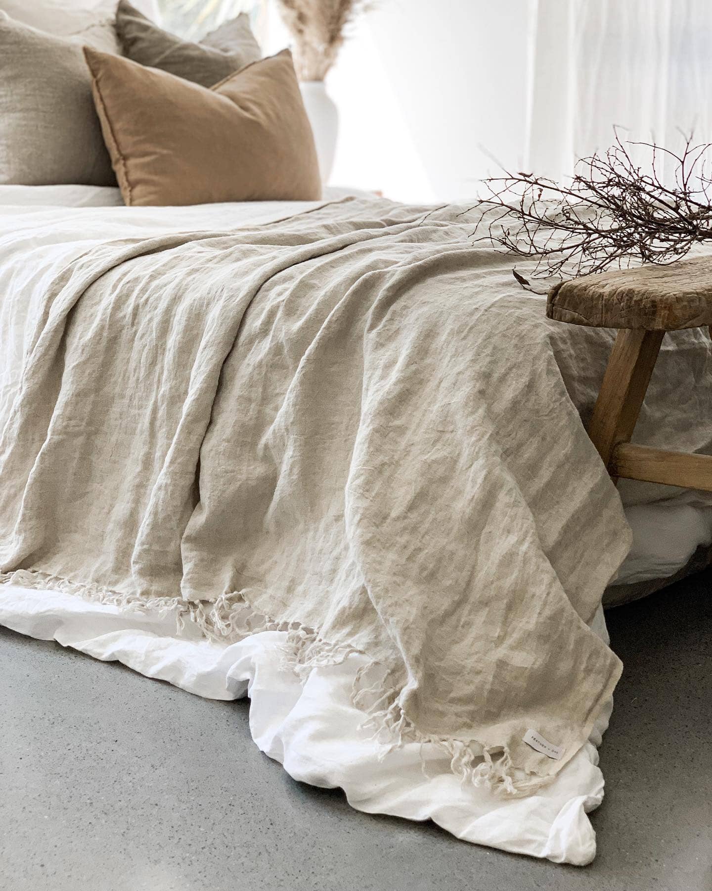 Natural Omala pure European linen throw blanket draped over luxury bed styling