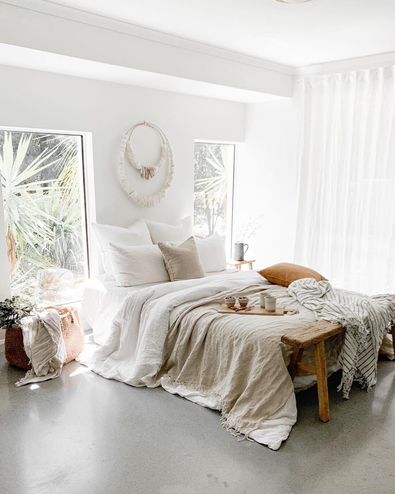 Cozy bedroom with a bed, pillows, and a wooden side table.