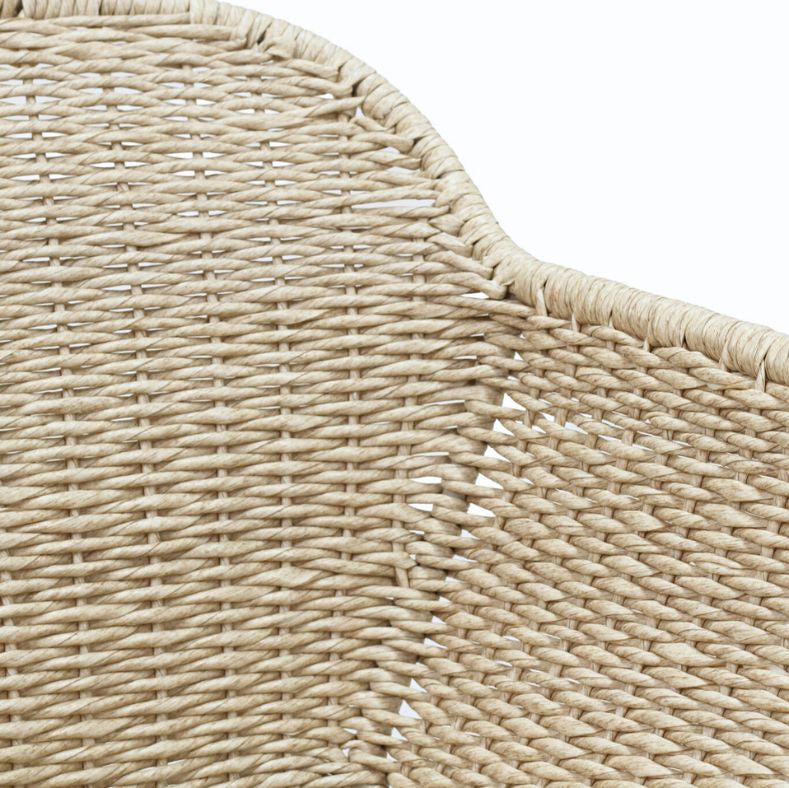 Close-up detail of a woven natural fiber product, showing the texture and curved edge on a white background.