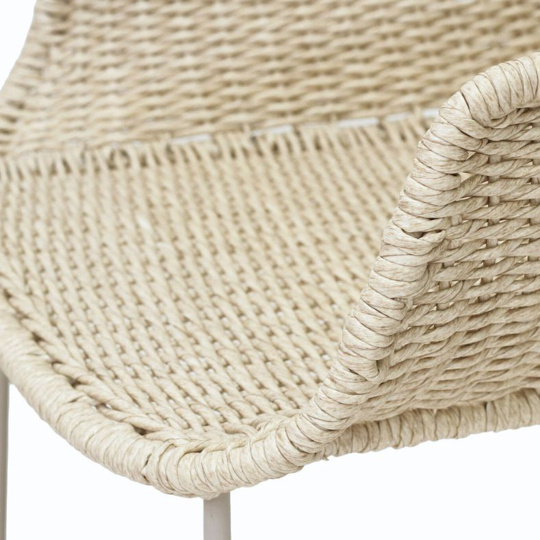 Close-up detail of a woven outdoor chair seat in a natural beige jute or seagrass material, showing the tight texture and curved armrest edge, on a white background.