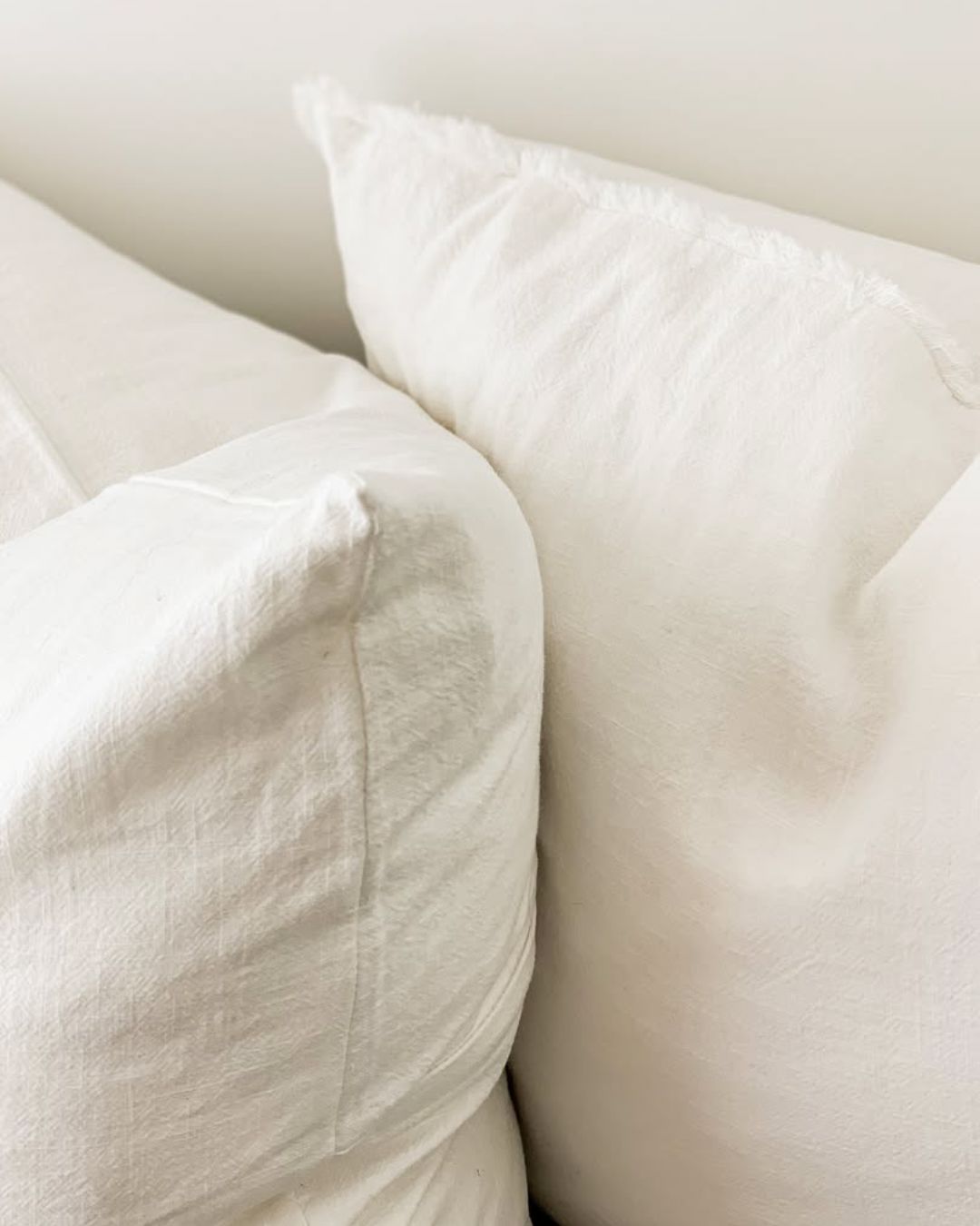 Close-up of white pillows on a neutral background